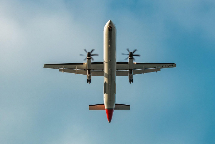 There is a football-sized UFO under the wing of an airplane