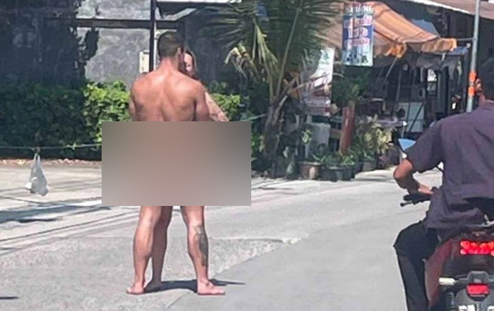 A couple in their 20s hugging naked on the road to a tourist destination in Thailand...an expression of love