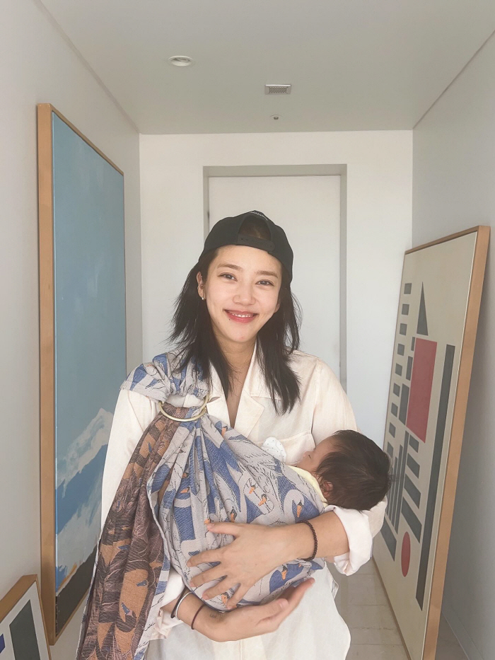 Son Dambi, you're two months old and your beauty is...The girl holding her daughter in her arms. 