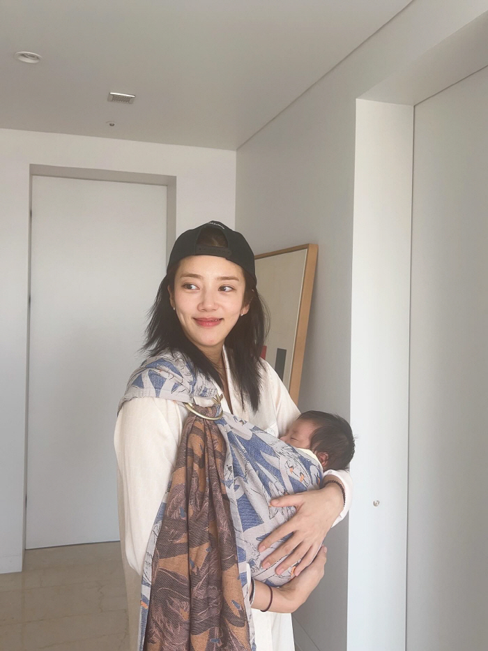 Son Dambi, you're two months old and your beauty is...The girl holding her daughter in her arms. 