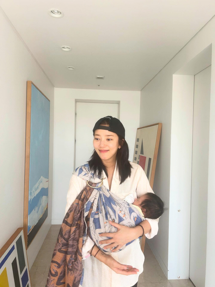 Son Dambi, you're two months old and your beauty is...The girl holding her daughter in her arms. 
