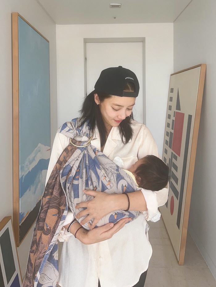 Son Dambi, you're two months old and your beauty is...The girl holding her daughter in her arms. 