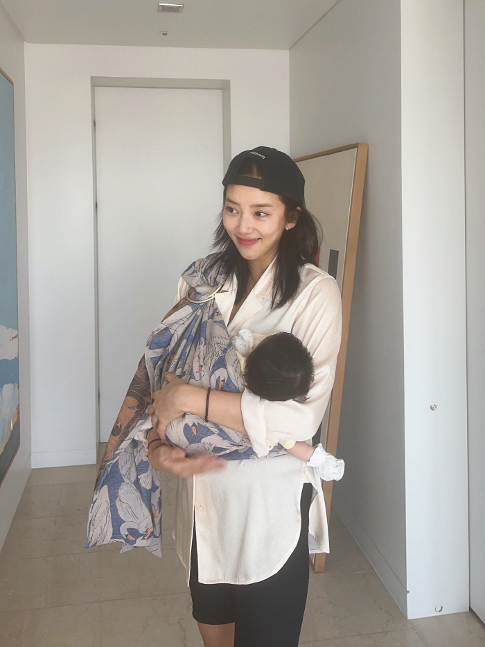 Son Dambi, you're two months old and your beauty is...The girl holding her daughter in her arms. 