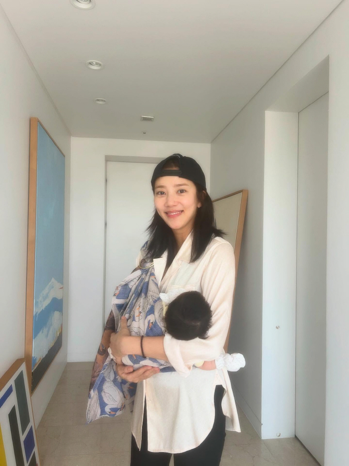 Son Dambi, you're two months old and your beauty is...The girl holding her daughter in her arms. 