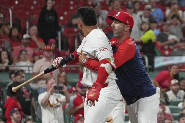 What kind of immoral behavior is this? It's a mistake, but STL's designated hitter's frowned upon throwing the bat at his team's coach