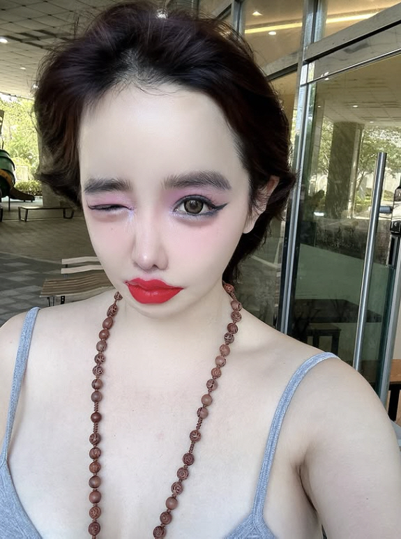 Park Bom's beauty covered by excessive makeup...Pink eyeshadow with beads. 