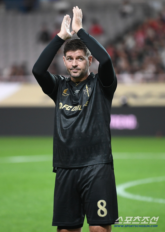  Gerrard smiles at fans' cheers