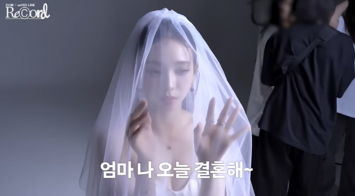 'Mom, I'm getting married.' Karina wears her first wedding dress and looks innocent with angel wings