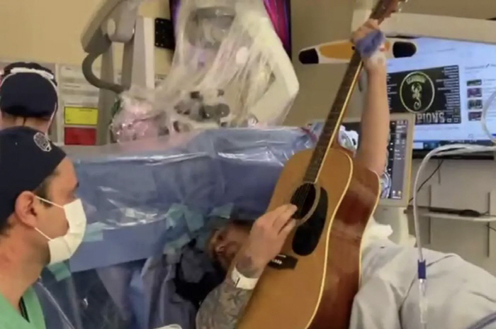 Male Surreal Experience Playing Guitar During Brain Tumor Surgery