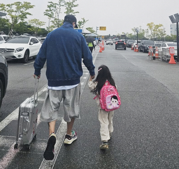 KCM holds her daughter's first open hand for 12 years and is happiest in a normal moment