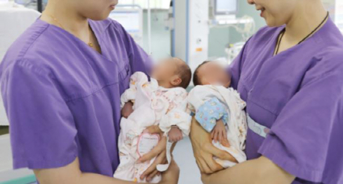 52 year old woman gives birth to twins by emergency cesarean section...In vitro treatment in February of this year